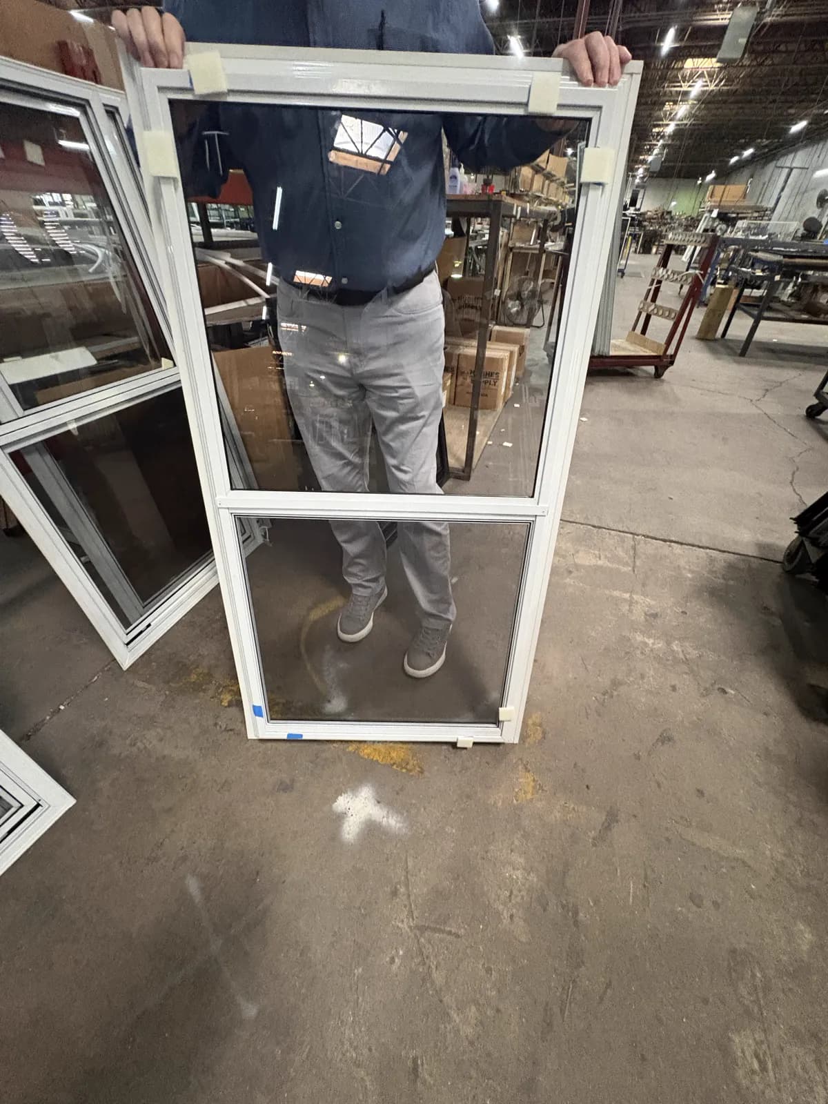 White two-track vertical storm window in production